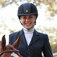 Jamie Radebaugh standing next to her horse